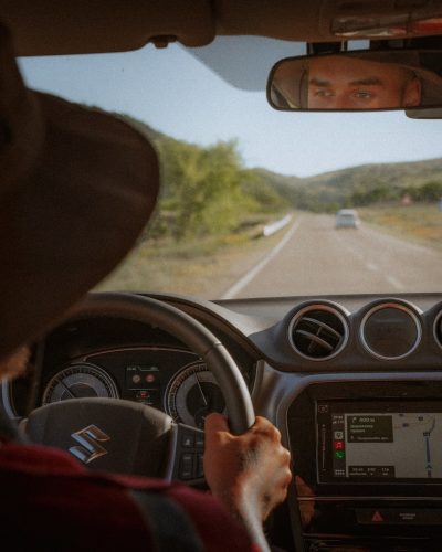 person driving car on road during daytime